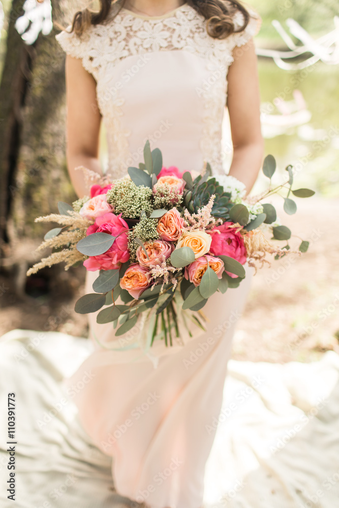 Bride in pink dress with beautiful bouquet Bride in pink dress with beautiful bouquet