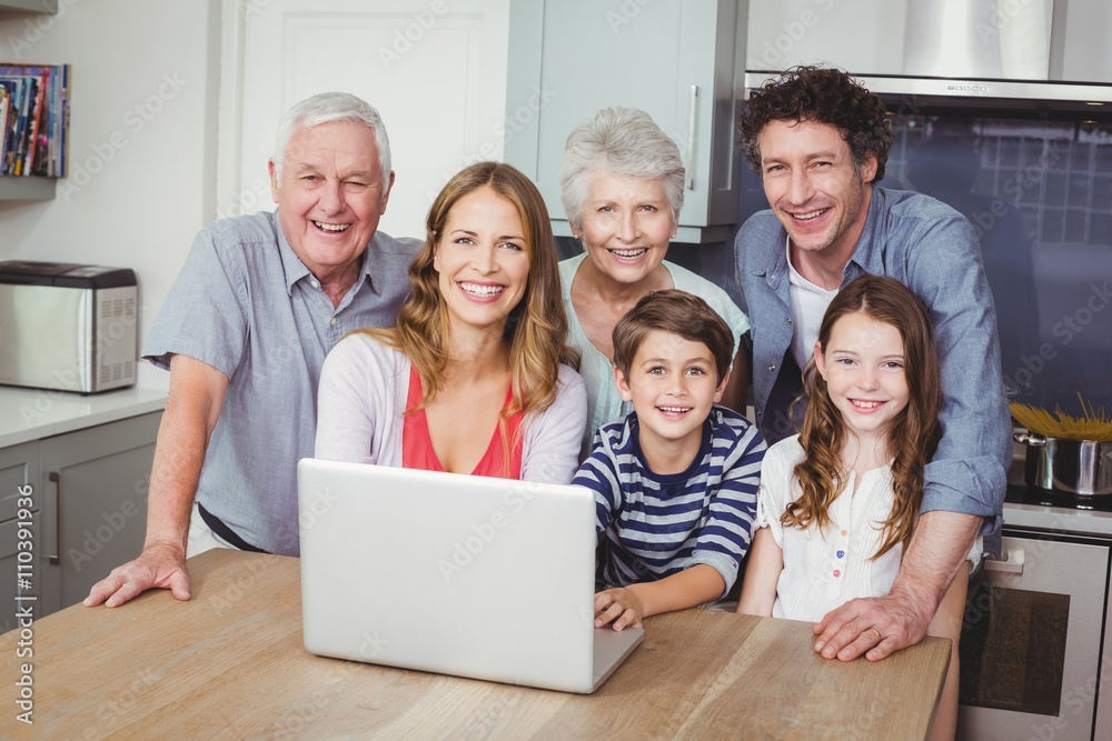 Portrait of happy family using laptop in kitchen Portrait of happy family using laptop in kitchen