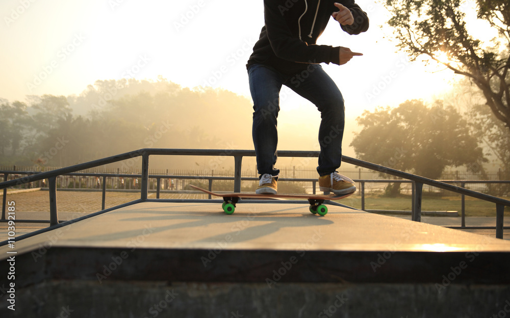 skateboarding woman practice ollie at skatepark