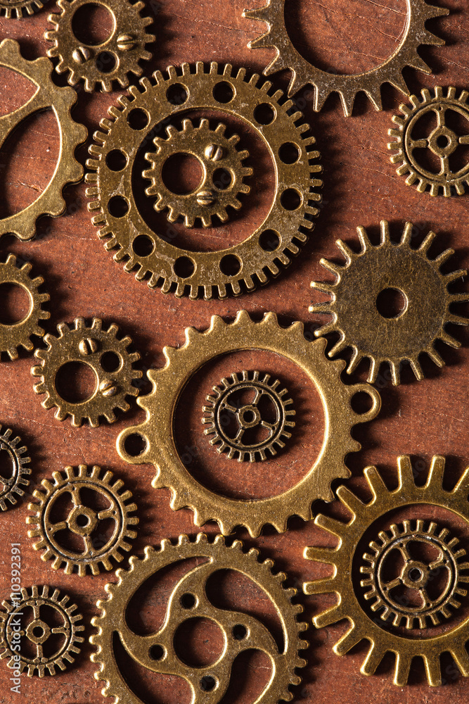 steampunk mechanical cogs gears wheels on wooden background steampunk mechanical cogs gears wheels on wooden background
