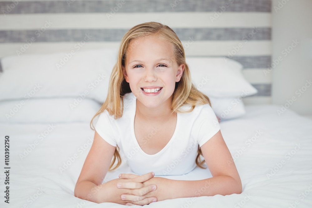 Portrait of smiling girl relaxing on bed Portrait of smiling girl relaxing on bed