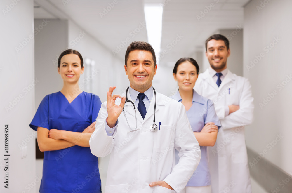group of medics at hospital showing ok hand sign group of medics at hospital showing ok hand sign