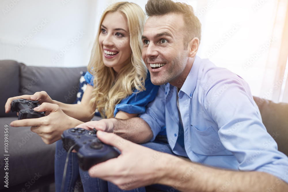 Couple having fun while playing video game Couple having fun while playing video game