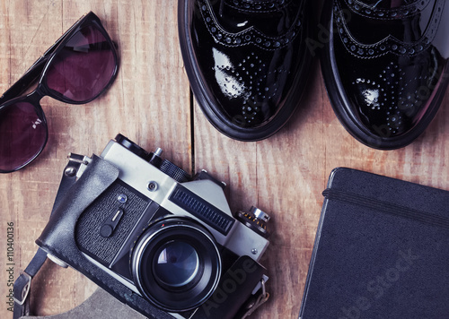 Shoes, vintage camera, notepad and sunglasses