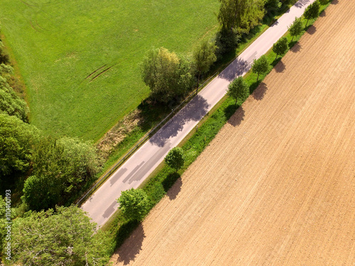 aerial view of village road and harvest fields in germany