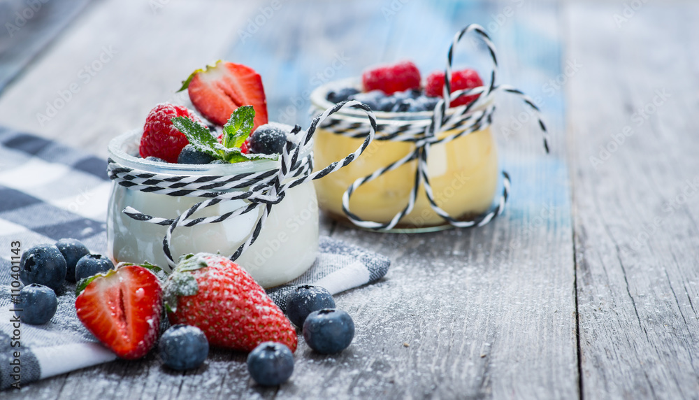 Fresh and healthy natural yogurt with berries on wooden table