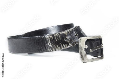 Photography Old leather belt torn on white background.