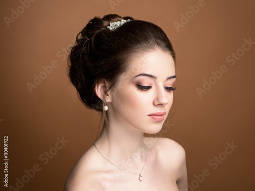 Beautiful sensual brunnete with elegant hairstyle. Wedding acces