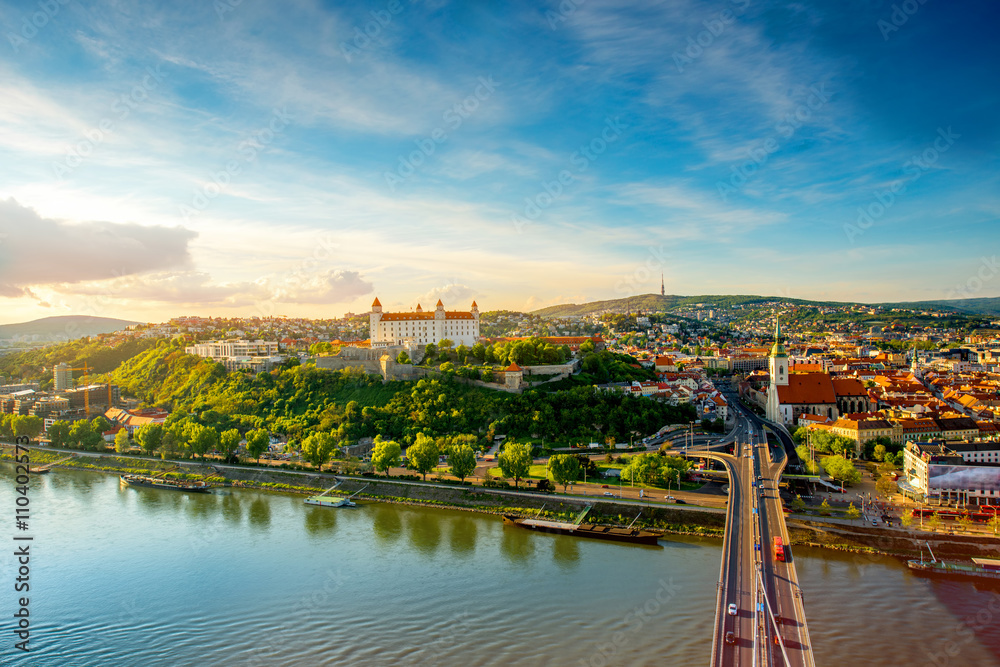 Bratislava aerial cityscape view on the old town with Saint Martin's cathedral, castle hill and Danube river on the sunset in Slovakia. Wide angle view with copy space