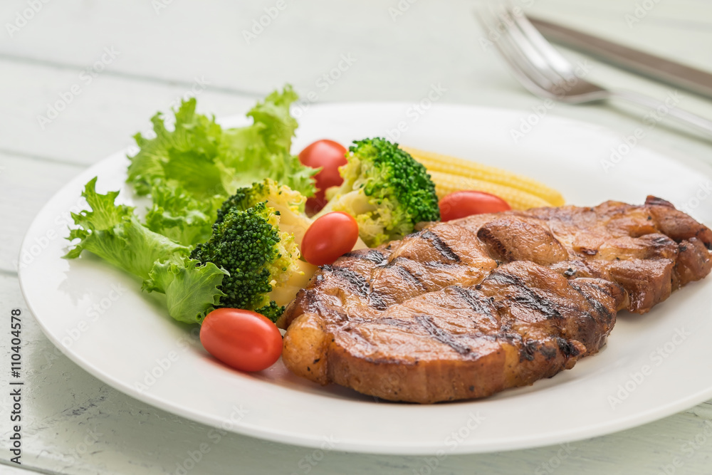 Grilled steak and vegetables on plate