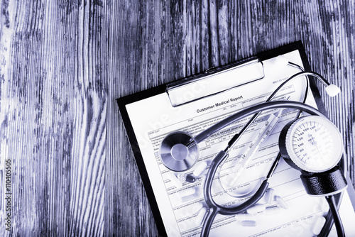 Medical concept of medical report with stethoscope and medicines photo