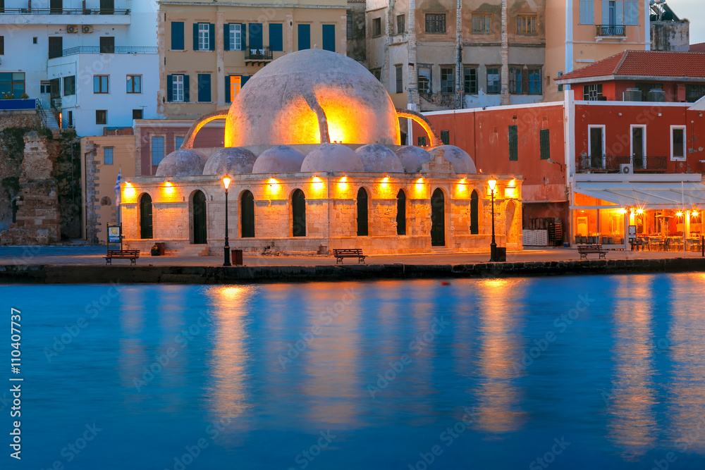 Picturesque view of Venetian quay of Chania with Kucuk Hasan Pasha Mosque during mornng blue hour, Crete, Greece