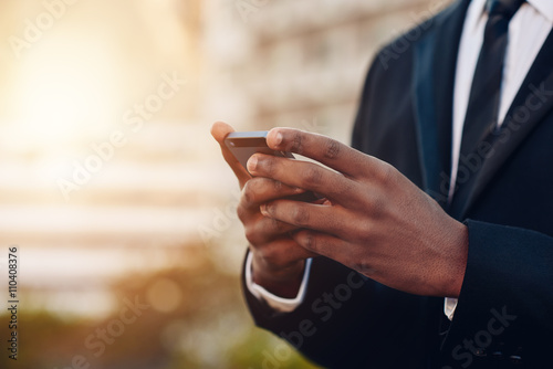 Cropped image of African buisnessman using mobile phone