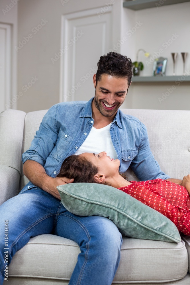Smiling romantic couple relaxing on sofa Smiling romantic couple relaxing on sofa