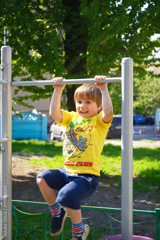 Little boy at playground plays sports. Fitness motivation Little boy at playground plays sports. Fitness motivation