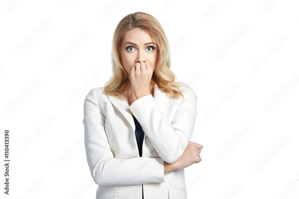 Shocked young woman covers her mouth with hands on light background Shocked young woman covers her mouth with hands on light background
