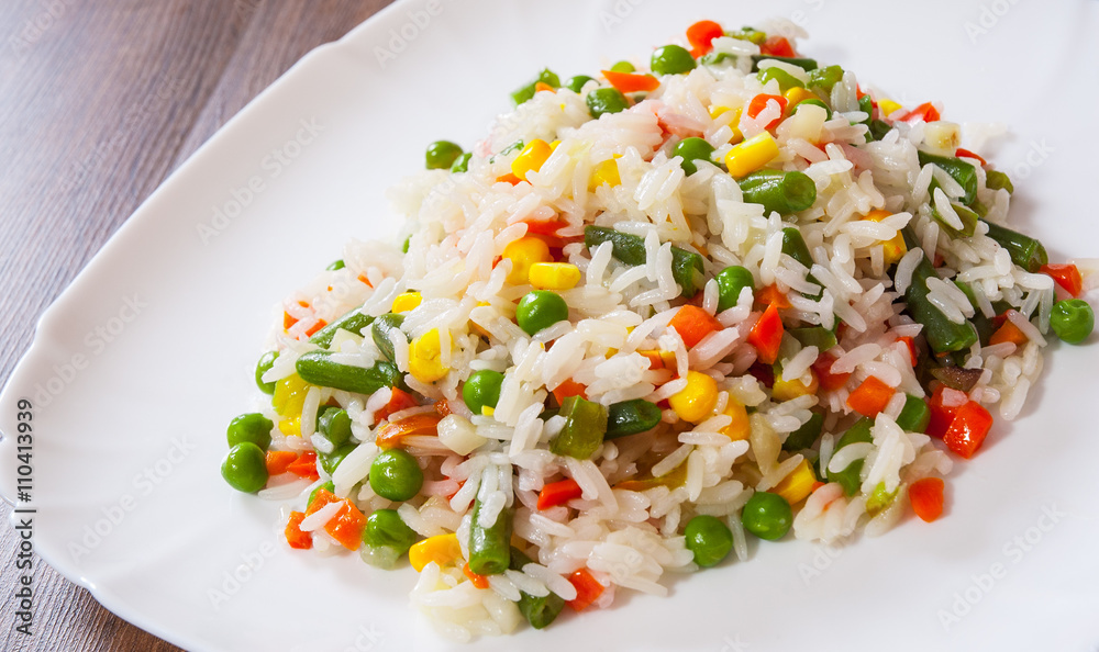Rice with mixed vegetables on white plate Rice with mixed vegetables on white plate