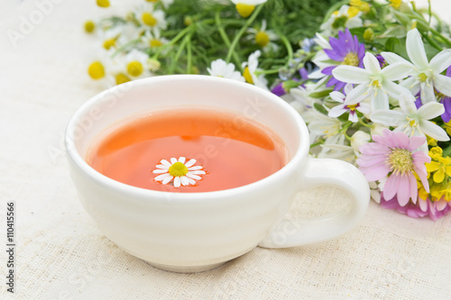 tea with chamomile and garden flowers