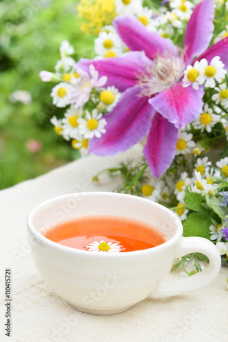 tea with chamomile and garden flowers