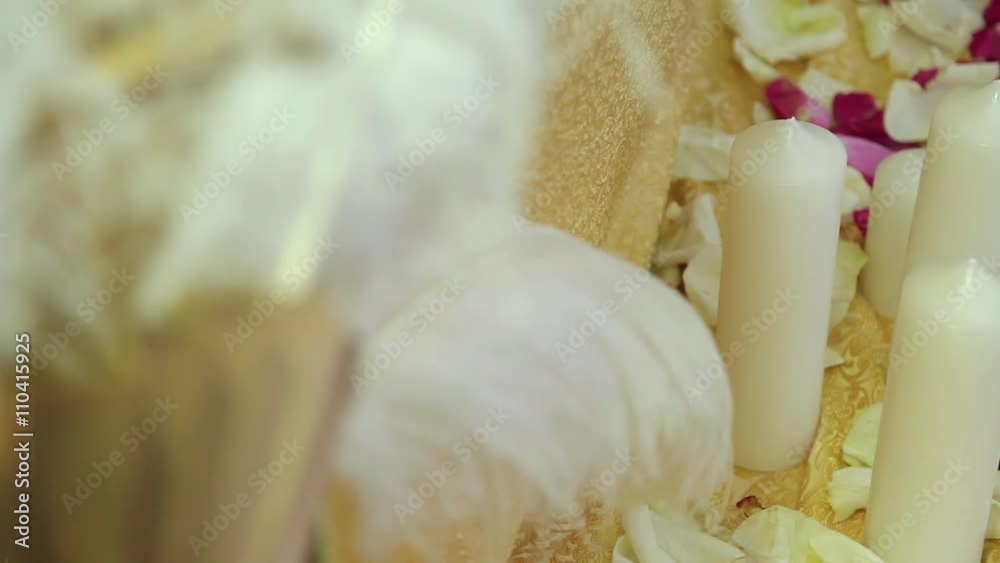 Candles with feathers and petal, dynamic change of focus Candles with feathers and petal, dynamic change of focus
