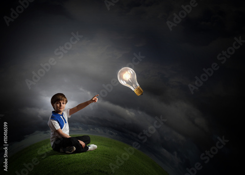 Boy pointing light bulb © Sergey Nivens