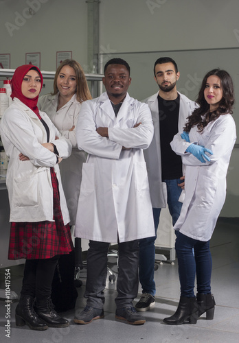 Group of young medical workers are working in lab as lab technicians