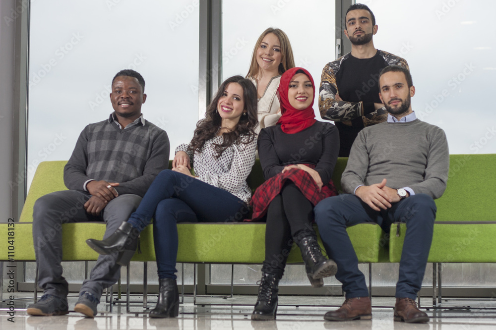 Fototapeta premium Group of students are hanging out in university hall, mixed-race
