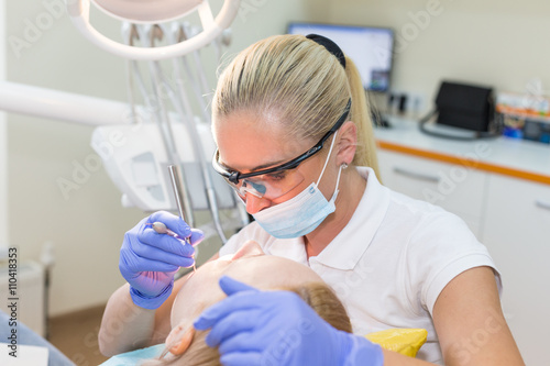 Woman doctor dentist with patient