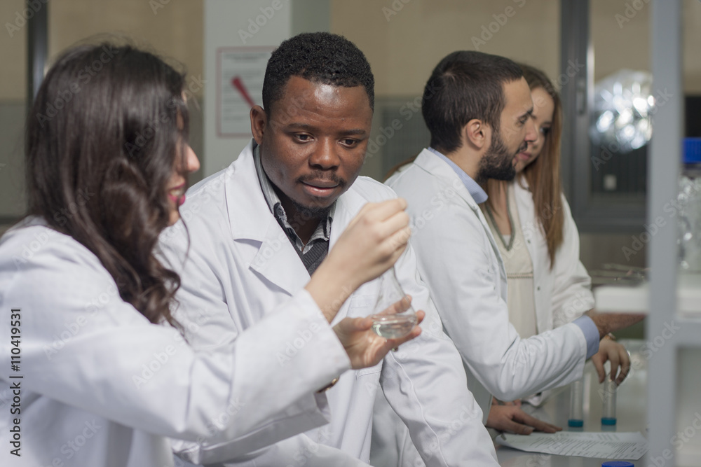 Group of young medical workers are working in lab as lab technic Group of young medical workers are working in lab as lab technic