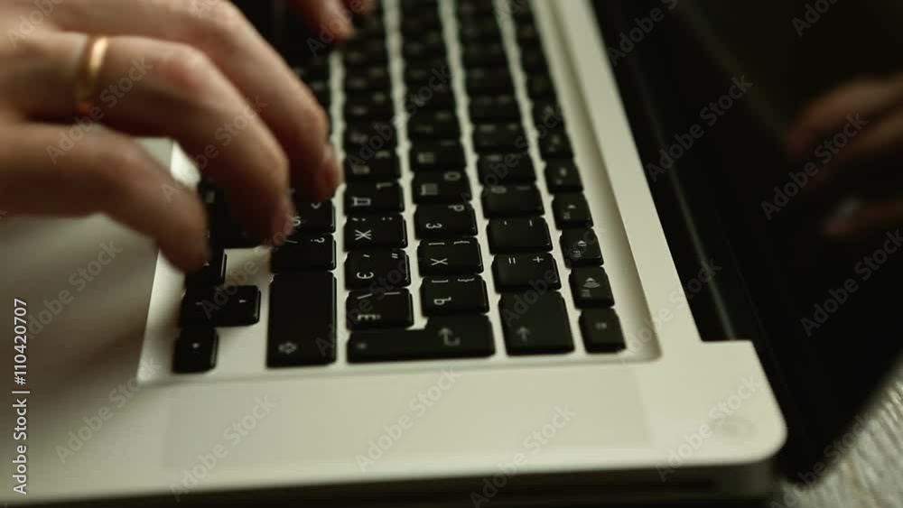 Close up of businessman hands typing on laptop computer on wooden table Close up of businessman hands typing on laptop computer on wooden table