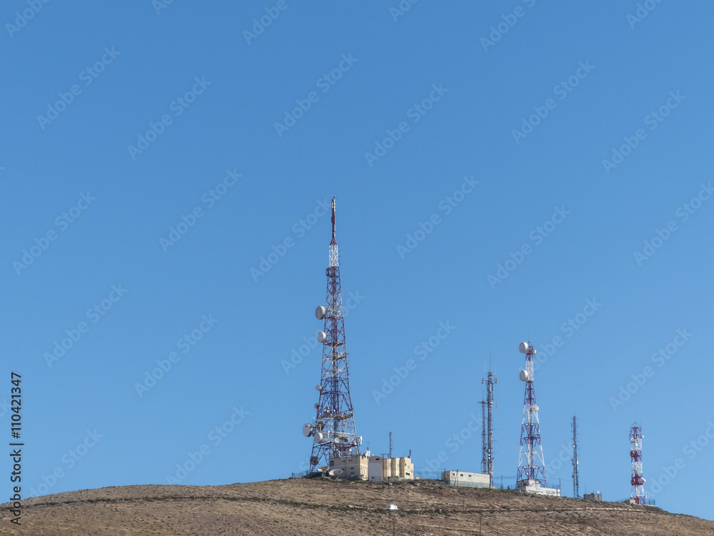 Three telecommunication masts on a mountain top. Three telecommunication masts on a mountain top.