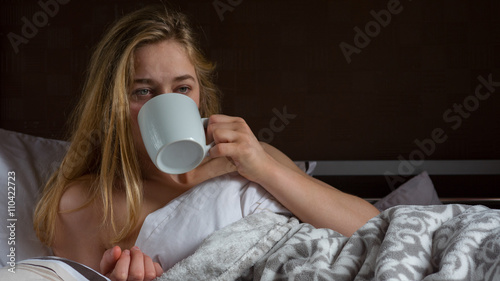A woman drinking coffee on a bleak morning