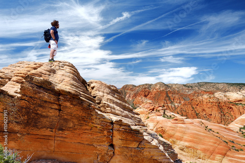 Hiker admiring views of sandstone formations of Yant Flat