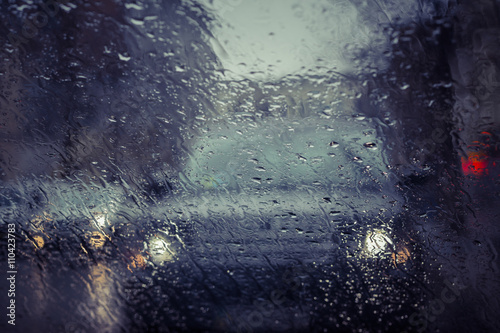 Rainy city street seen through the car windshield