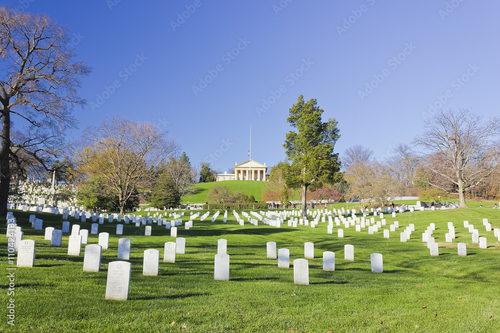 Poignant rows of marble headstones in Section 32 at Arlington National Cemetery with Arlington House beyond at the top of the Hill, Virginia Poignant rows of marble headstones in Section 32 at Arlington National Cemetery with Arlington House beyond at the top of the Hill, Virginia