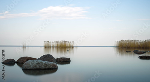 Tableau sur toile the blue sky is reflected Ladoga lake in evening