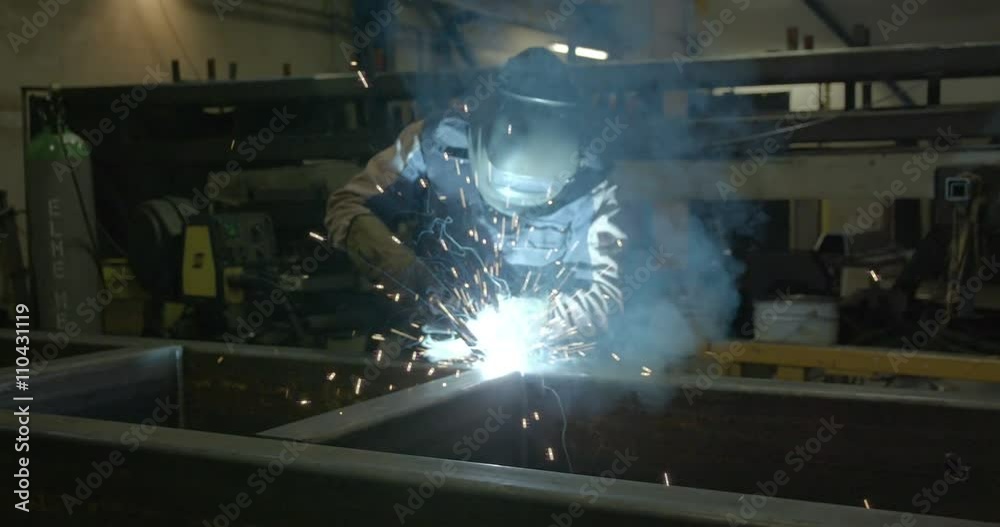 Closer shot of the welding process of a big metal part of the equipment Closer shot of the welding process of a big metal part of the equipment