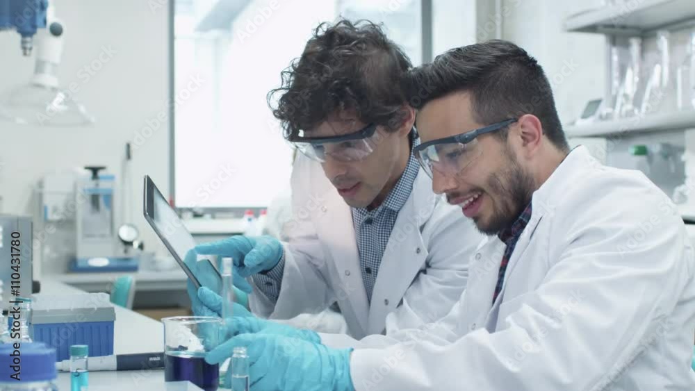 Team of Multiethnic Students in Coats Working in Laboratory of Chemistry Classroom. Shot on RED Cinema Camera. Team of Multiethnic Students in Coats Working in Laboratory of Chemistry Classroom. Shot on RED Cinema Camera.