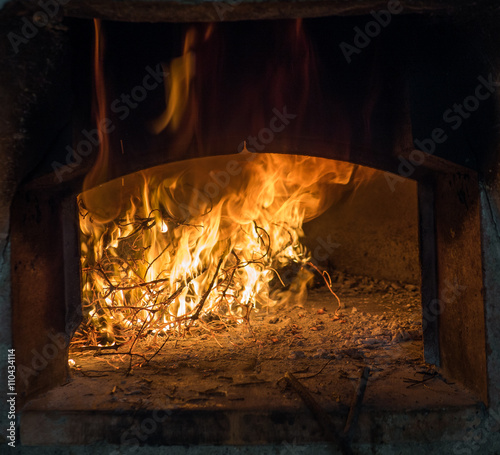 Flames from wood burning in a traditional oven in Italy