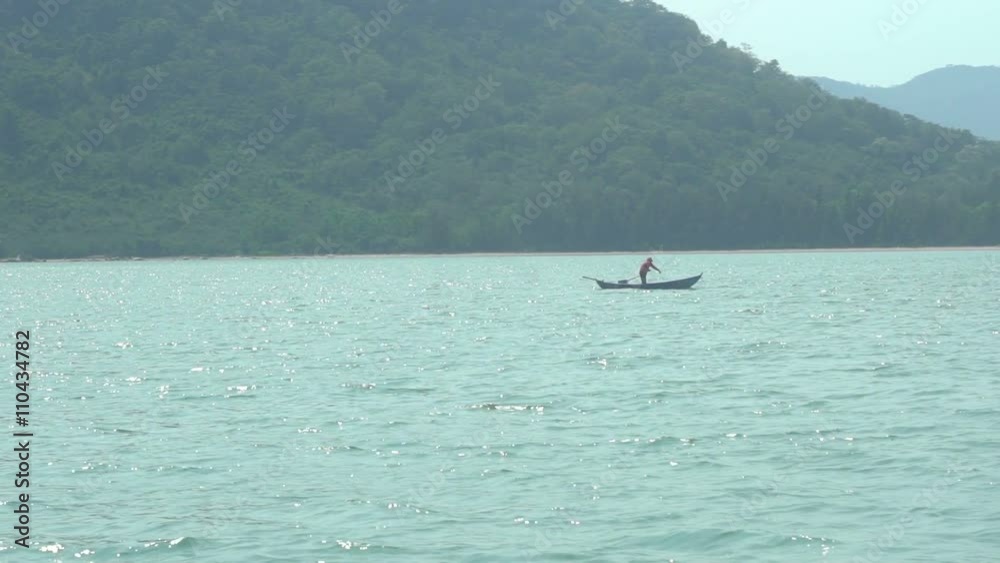 fisherman on a boat in a turquoise bay 2 fisherman on a boat in a turquoise bay 2