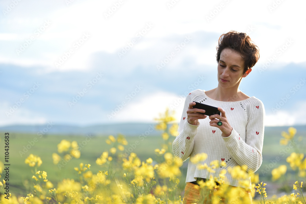 Young woman using her smart phone in the outdoors Young woman using her smart phone in the outdoors