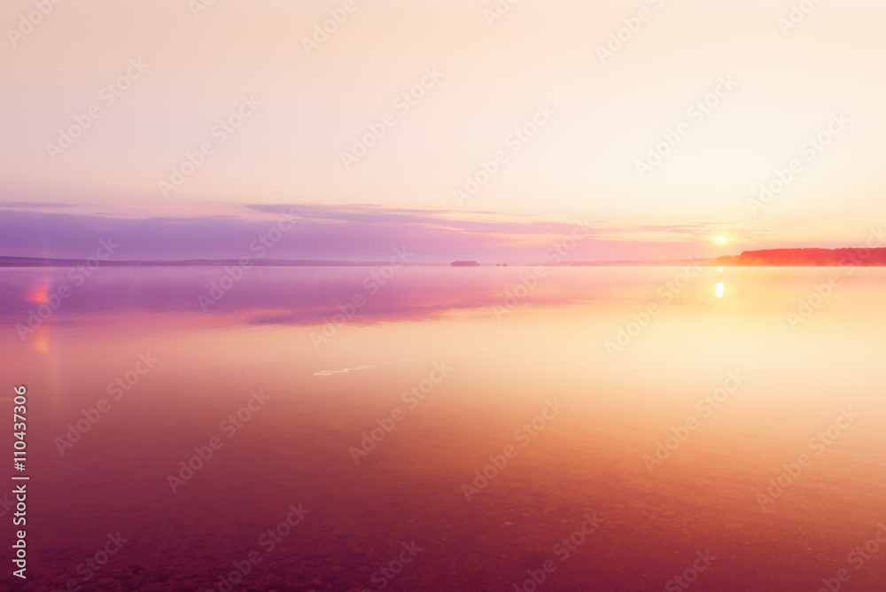Landscape with sunrise on lake beach