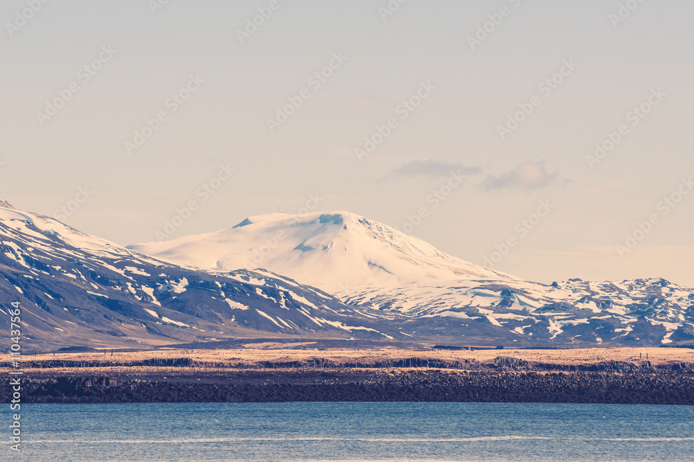 Snow on mountains by the sea