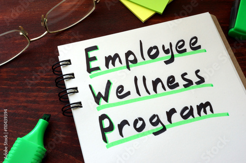 Employee Wellness program written on a notepad with marker. photo