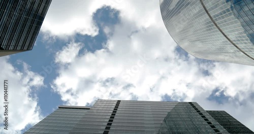 Corporate buildings and timelapse clouds fast
