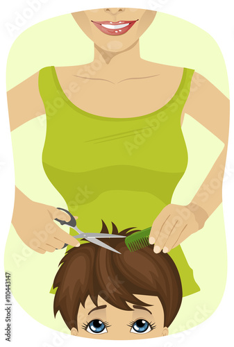 little boy getting a haircut at the barber shop