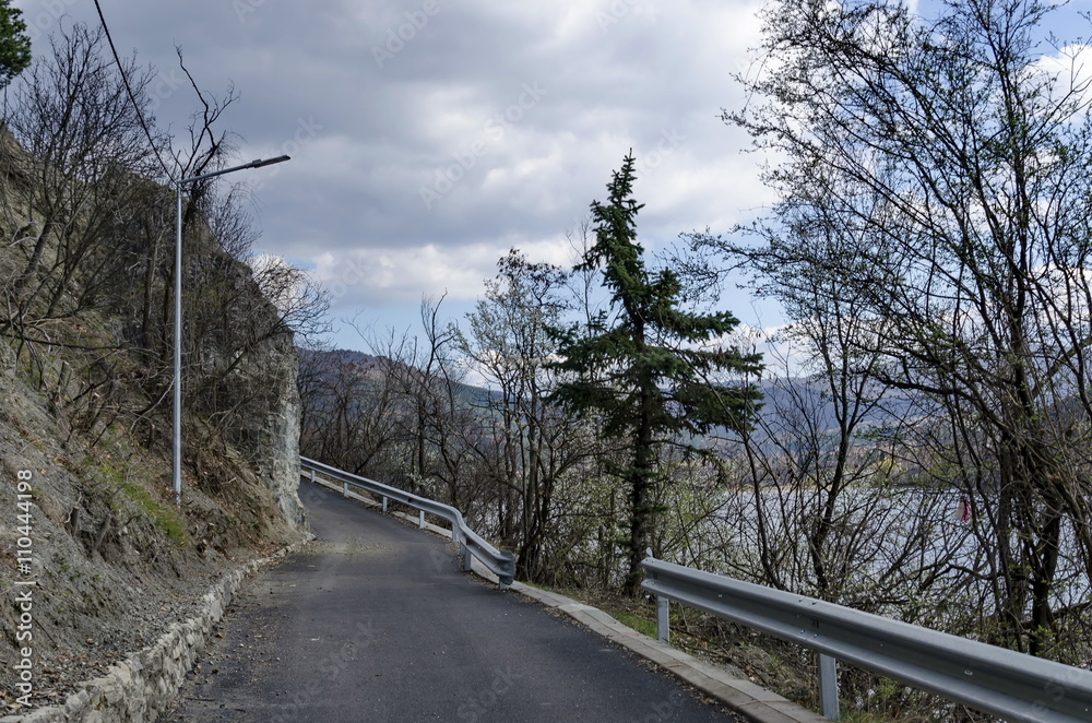 Picturesque road at Lozen mountain in springtime cloudy day,  Pancharevo, Bulgaria   - obrazy, fototapety, plakaty 