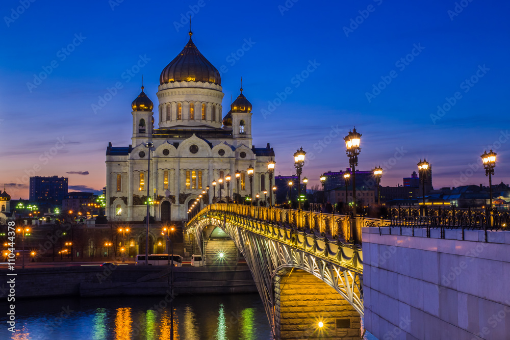 Moscow - Majestic orthodox Cathedral of Christ Saviour illuminated at dusk on bank of Moscow river. It is tallest Orthodox church in world.