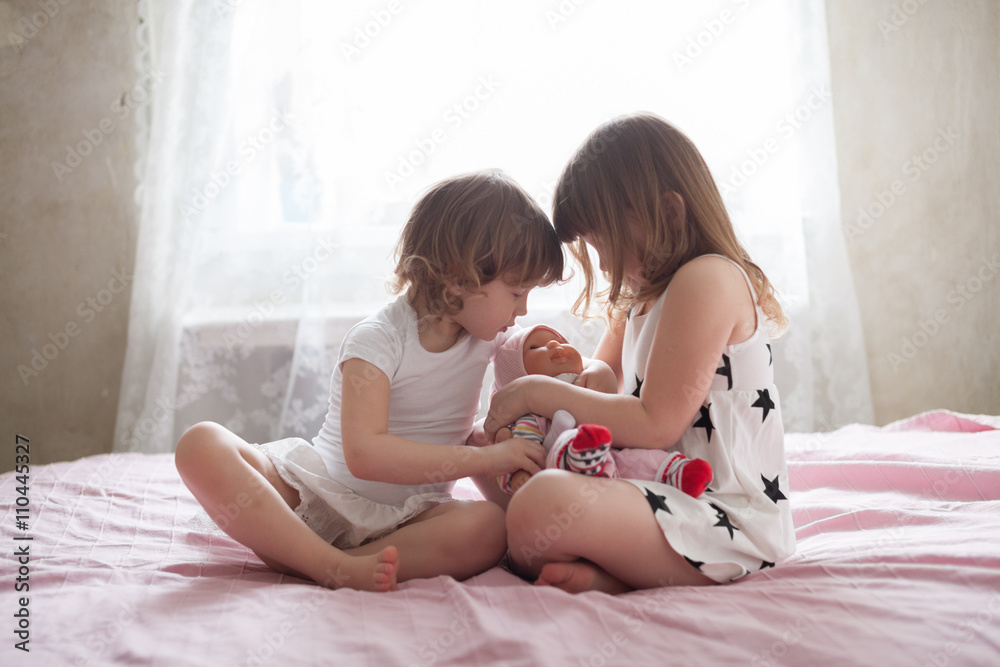 girls siblings children playing doctor with toy at home