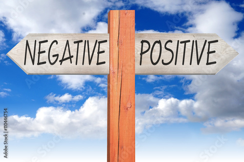Negative or positive - wooden signpost photo